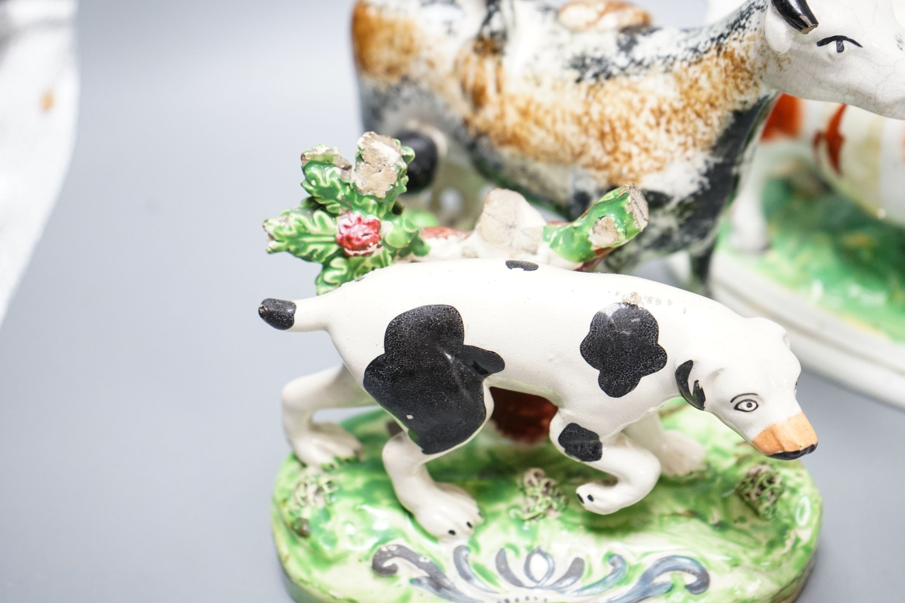 A 19th century 'Milkmaid and cow' creamer with sponged decoration, three other Staffordshire items and a Continental majolica figure of a turkey (5)